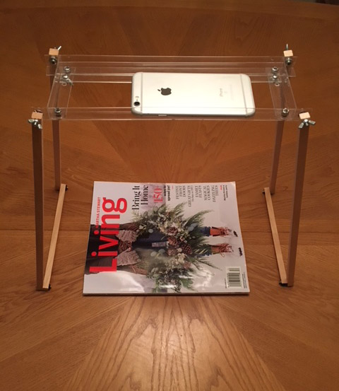Picture of stand with phone looking down on magazine